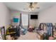 Bedroom with neutral walls, carpet, ceiling fan, and TV, although currently filled with boxes and items at 205 Yellow Hawthorn Cir, Summerville, SC 29483