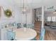 Charming dining area with light blue accents and decorative wreath, adjacent to carpeted staircase at 205 Yellow Hawthorn Cir, Summerville, SC 29483