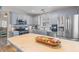 Well-lit kitchen features stainless steel appliances, gray cabinets, and a large island, perfect for culinary enthusiasts at 205 Yellow Hawthorn Cir, Summerville, SC 29483
