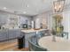Open concept kitchen features stainless steel appliances, grey cabinets, and island with bar seating at 205 Yellow Hawthorn Cir, Summerville, SC 29483