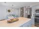 Spacious kitchen island overlooks breakfast table with blue chairs; ideal for entertaining at 205 Yellow Hawthorn Cir, Summerville, SC 29483