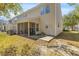 Exterior view featuring a screened porch and concrete patio in a yard covered with fallen leaves at 205 Yellow Hawthorn Cir, Summerville, SC 29483