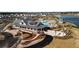 Stunning aerial view of community pool, clubhouse, and surrounding neighborhood with sidewalks and adjacent lake at 207 Billinger St, Summerville, SC 29486