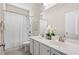 Bright bathroom featuring a double sink vanity, a large mirror, and a shower with white curtain at 207 Billinger St, Summerville, SC 29486