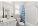 Well-lit bathroom featuring a combination shower and tub with a blue patterned curtain at 207 Billinger St, Summerville, SC 29486