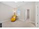 Cozy room featuring a yellow armchair, carpet, and a window for natural light at 207 Billinger St, Summerville, SC 29486
