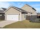 Exterior view of a two-car garage with a white door, adjacent to a well-maintained lawn at 207 Billinger St, Summerville, SC 29486