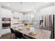 Bright kitchen featuring white cabinets, stainless appliances, a granite island, and stylish pendant lighting at 207 Billinger St, Summerville, SC 29486