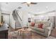 Cozy living room with hardwood floors that seamlessly connects to the kitchen and stairs at 207 Billinger St, Summerville, SC 29486
