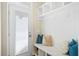 Organized mudroom with bench, storage cubbies, coat hooks, and a door to the outside at 207 Billinger St, Summerville, SC 29486