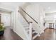Elegant staircase with hardwood treads and white risers adjacent to the kitchen at 207 Billinger St, Summerville, SC 29486
