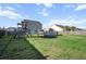 Expansive backyard featuring a swing set, above ground pool, green grass, and storage shed at 2150 Pimlico Dr, Ridgeville, SC 29472
