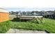 Backyard view of wooden pool deck and green lawn, perfect for outdoor entertaining at 2150 Pimlico Dr, Ridgeville, SC 29472