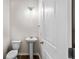Tastefully designed half bathroom with a pedestal sink and modern lighting fixtures at 2150 Pimlico Dr, Ridgeville, SC 29472