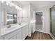 Bathroom featuring double sinks, white cabinets, and modern lighting at 2150 Pimlico Dr, Ridgeville, SC 29472