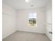 Clean bedroom with carpet, window, and closet organizer at 2150 Pimlico Dr, Ridgeville, SC 29472
