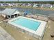 Aerial view of the community pool, playground and lake with surrounding homes in the neighborhood at 2150 Pimlico Dr, Ridgeville, SC 29472