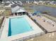 Aerial view of the community pool, playground and lake with surrounding homes in the neighborhood at 2150 Pimlico Dr, Ridgeville, SC 29472