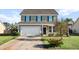 Charming two-story home with siding, a driveway, an attached two car garage, and a well-maintained front lawn at 2150 Pimlico Dr, Ridgeville, SC 29472
