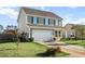 Charming two-story home with siding, a driveway, an attached two car garage, and a well-maintained front lawn at 2150 Pimlico Dr, Ridgeville, SC 29472
