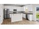 Bright kitchen featuring stainless appliances, mosaic backsplash, and modern white cabinets at 2150 Pimlico Dr, Ridgeville, SC 29472