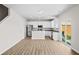 Modern open-concept kitchen with white cabinets, stainless steel appliances, and a door leading to an outdoor space at 2150 Pimlico Dr, Ridgeville, SC 29472
