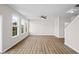 Open-concept living room with natural light, modern ceiling fan, and wood-look flooring at 2150 Pimlico Dr, Ridgeville, SC 29472
