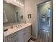 Bright bathroom featuring a white vanity, modern fixtures, large mirror, and stylish decor and view to shower at 2164 Highway 78, Dorchester, SC 29437