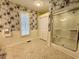Charming bathroom with shower, wainscoting, neutral colors, and floral wallpaper at 2164 Highway 78, Dorchester, SC 29437