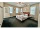 A bedroom with a bed, two windows, and a door to the outside. The room is decorated with an overhead fan at 2164 Highway 78, Dorchester, SC 29437