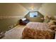 Cozy room in the attic with a bed, futon and floral wallpaper at 2164 Highway 78, Dorchester, SC 29437