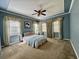 Spacious bedroom with blue walls, carpet, a ceiling fan, and large windows with curtains at 2164 Highway 78, Dorchester, SC 29437