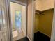 An empty closet with hangers, next to a bathroom with a view of the bathroom and its white cabinets at 2164 Highway 78, Dorchester, SC 29437