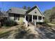 Inviting home exterior with a covered porch, brick walkway, and beautiful landscaping at 2164 Highway 78, Dorchester, SC 29437