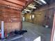 The garage interior has wood walls, a cement floor, lighting, a Personal door, and visible electrical and plumbing at 2164 Highway 78, Dorchester, SC 29437