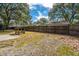 Spacious backyard features a wooden fence and mature trees, offering privacy at 2306 Chairmaker Ct, Charleston, SC 29414