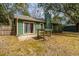 Backyard of home features a sliding door entrance, patio and detached shed at 2306 Chairmaker Ct, Charleston, SC 29414