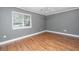 Comfortable bedroom featuring hardwood floors, neutral gray paint, and a window at 2306 Chairmaker Ct, Charleston, SC 29414