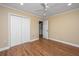 Neutral bedroom with hardwood floors, ceiling fan, recessed lighting, closet, and two doors at 2306 Chairmaker Ct, Charleston, SC 29414
