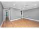 Spacious bedroom with hardwood floors, a ceiling fan, and an open doorway to an ensuite bathroom at 2306 Chairmaker Ct, Charleston, SC 29414