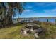 Enjoy waterfront living with a private dock and lovely stone table for outdoor seating and relaxation at 2306 Chairmaker Ct, Charleston, SC 29414