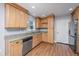 Well-lit kitchen with light wood cabinets, granite countertops, and stainless steel appliances at 2306 Chairmaker Ct, Charleston, SC 29414