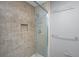 Bathroom shower features a glass enclosure and tiled walls with built-in shelving for added convenience at 2306 Chairmaker Ct, Charleston, SC 29414