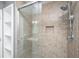 Bathroom shower features a glass enclosure and tiled walls with built-in shelving and shower caddy at 2306 Chairmaker Ct, Charleston, SC 29414