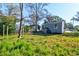 A backyard featuring a storage shed and other buildings with grassy lawn at 2314 Kent Ave, North Charleston, SC 29405