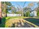 A spacious, green backyard with a wooden fence and some trees at 2314 Kent Ave, North Charleston, SC 29405