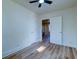 Bedroom with ceiling fan, wood-look flooring, and view into the kitchen at 2314 Kent Ave, North Charleston, SC 29405