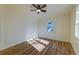 Bright bedroom with hardwood floors, a ceiling fan, and a large window offering natural light at 2314 Kent Ave, North Charleston, SC 29405