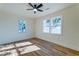 Bright bedroom with hardwood floors, a ceiling fan, and two large windows offering natural light at 2314 Kent Ave, North Charleston, SC 29405