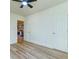 Neutral bedroom with ceiling fan, wood-look flooring, and adjacent kitchen view at 2314 Kent Ave, North Charleston, SC 29405